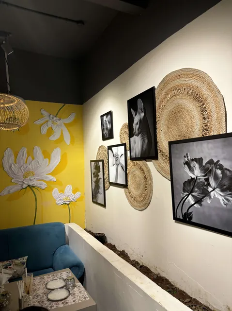 Art gallery and cafe wall with framed floral art prints